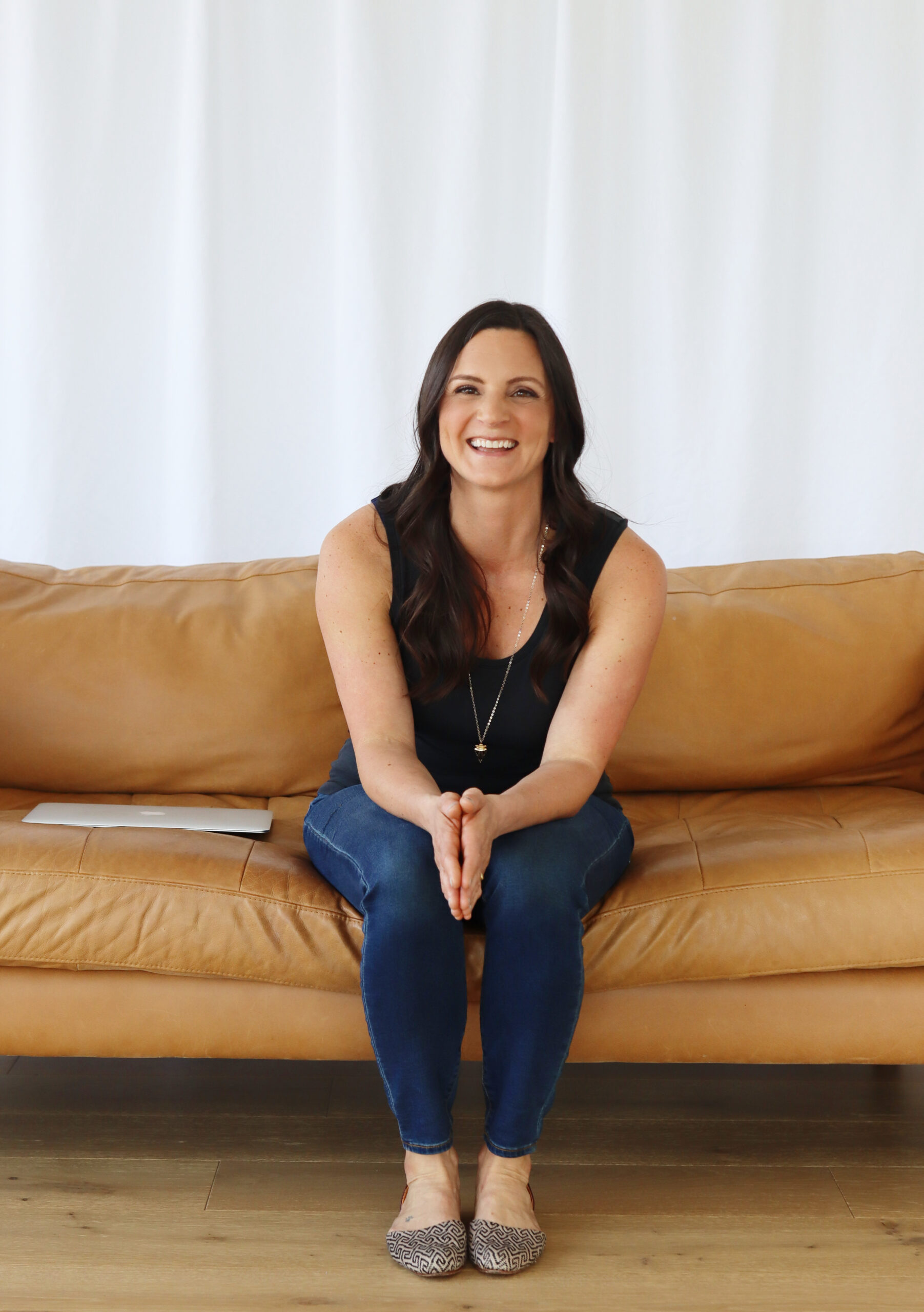 Nicole Pichette sitting comfortably on her office couch